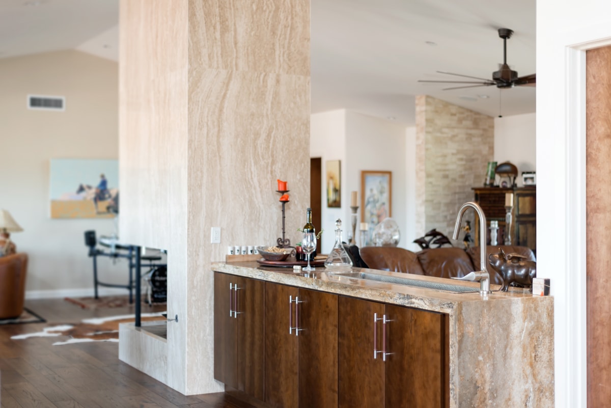 Wet bar situated between a kitchen and a living room.