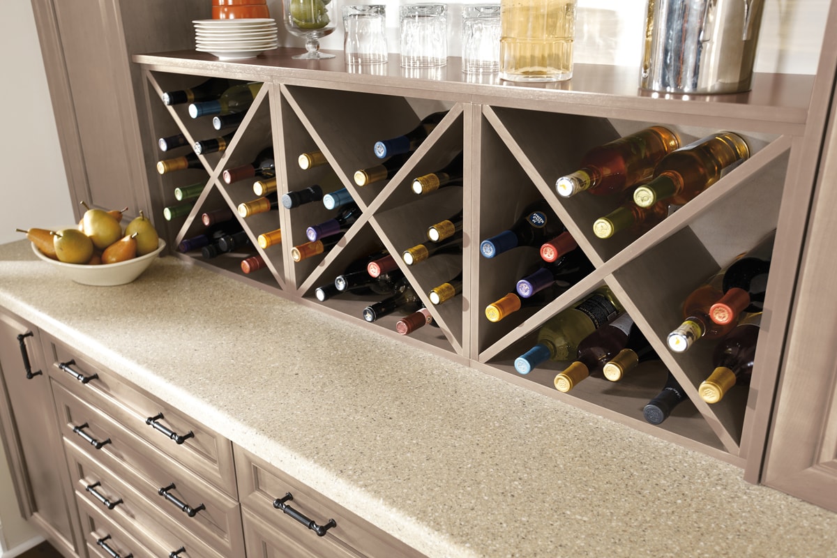 Three X-Shaped beige wine racks with wine bottles.