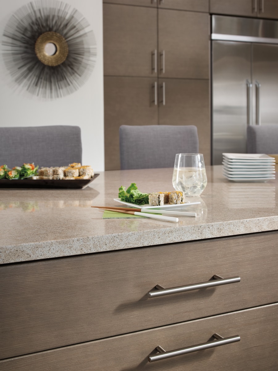 Netural wood bar with light countertops and bar seating.