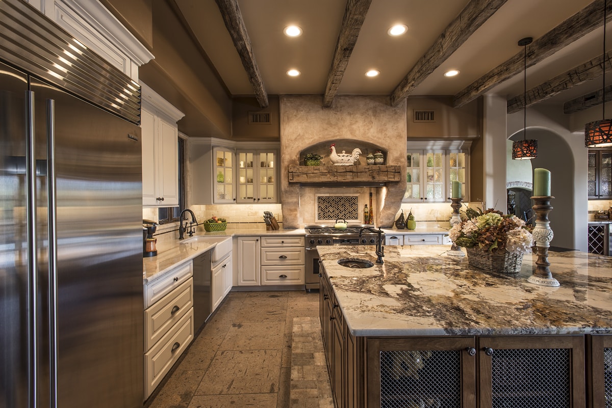 Traditional style kitchen with several warm brown tones and cream cabinetry.